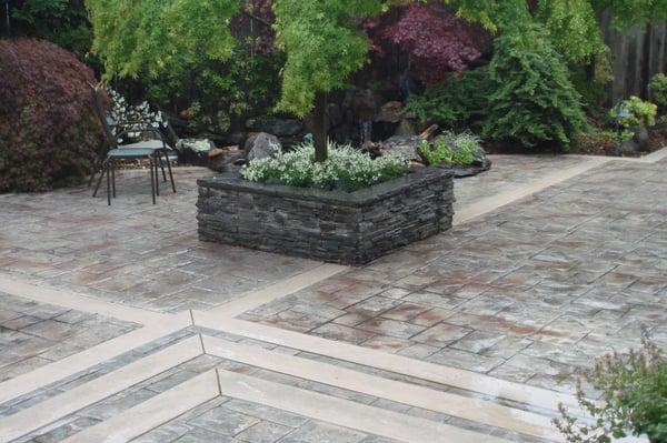 Stamped concrete patio with a flagstone planter box