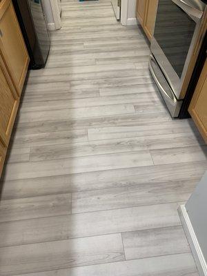 Same planks under kitchen lighting. Notice the color difference.  You need to bring home large mounted samples to see how the color looks.