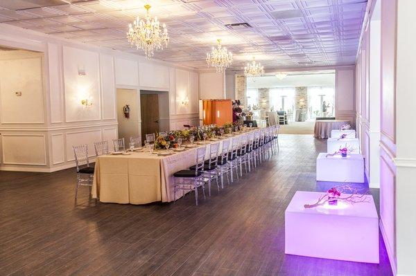 The Amanda room: Hardwood floors, neutral walls, and a touch of old world brick. The room can accommodate 165 people for a sit-down dinner