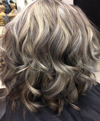 Mix of blondes, silvers and grays with a long-layered swing bob cut.