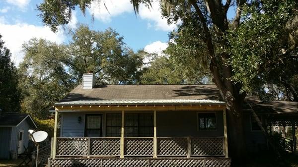 A porch we built 2x6 roof with Ash gray ruff rib metal roofing to help keep leaves off the porch and provide more shade.