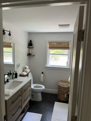 A look at a new bathroom finished and decorated. It shows how the new paint on ceiling, walls and trim really make the room look complete.