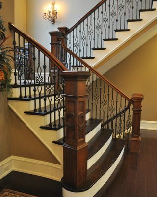 Metal balusters with Custom Walnut newel posts on Walnut staircase.