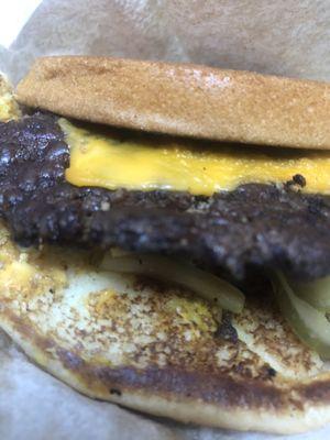 Some kind of cheeseburger with a burnt patty.  Not a quarter pounder.