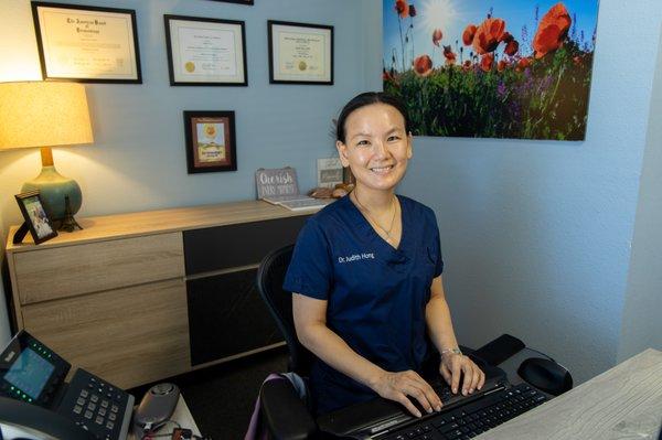 Judith Hong, MD, at her desk at Redwood Family Dermatology in Santa Rosa.