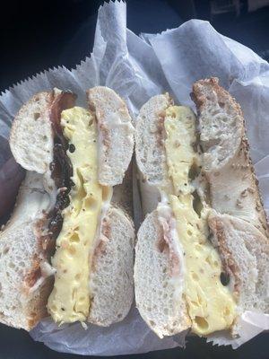 Bacon, egg and cheese with pepper and ketchup on sesame seed bagel