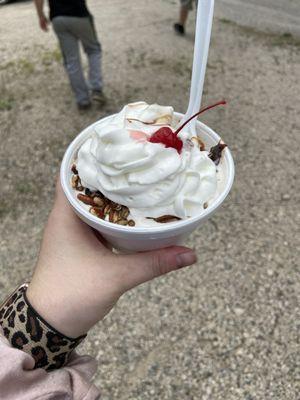 Turtle sundae with pecans, whipped cream and a cherry