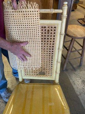 The hole worn in the bottom of the chair before repair.