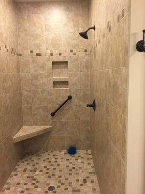 custom designed shower featuring ceramic tile, corner seat and two niches