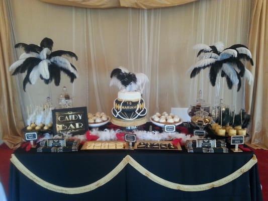 Dessert Table setup includes a cake,  cake pops, chocolate covered oreos, chocolate covered marshmallows, cupcakes...