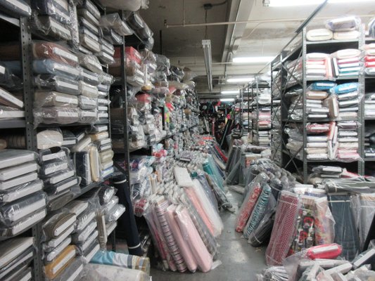 Full floor of apparel fabrics: linen, silk, cotton, wool, poly, etc.