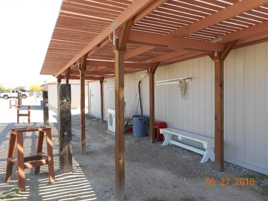 Main hitching rail, with saddle racks, and with covered arbor to provide place to relax out of the hot sun