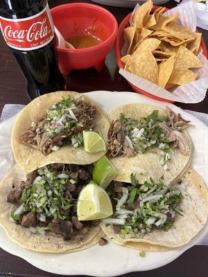 Carnitas and carne asada tacos, chips and salsa and a Mexican coke