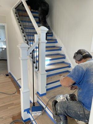 One of our workers refinishing this set of stairs!