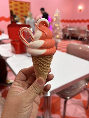 Mix of vanilla and dairy free peppermint ice cream cone with an extra candy cane.