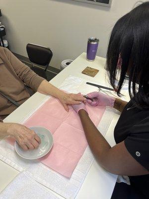 Manicure. Trim, cuticle, exfoliating, massage, and clear polish.