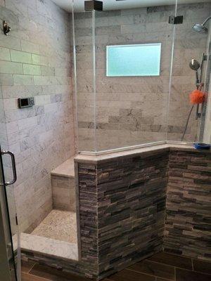 This is a shower bathroom,
 it has stone tile.