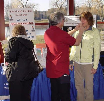 Demonstrating Emotional Freedom Technique at a Health Fair..