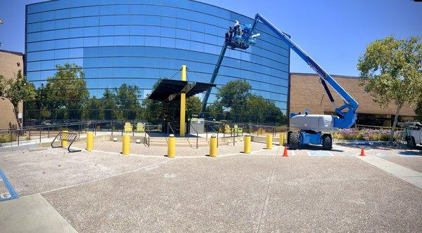 Exterior bird film application using a boom lift. Enhance your building's appearance and protect against birds.