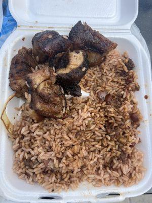 All fat pieces of jerk pork that taste flavorless and old for $15!