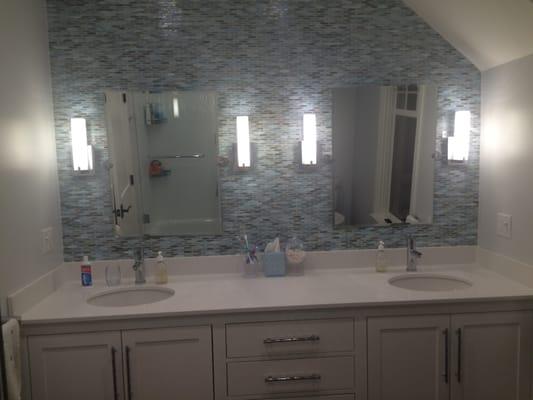 Kids' BA designed to look great when they're adults too. Love blue tile "wave" effect with white wavy tile in tub (reflected in L mirror).