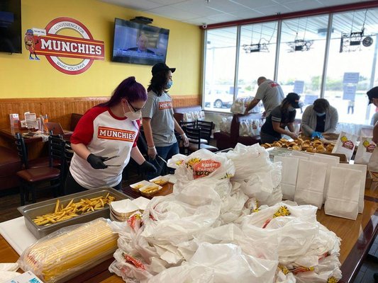 The Munchies staff hard at working packing bags to feed frontline workers during the COVID-19 pandemic