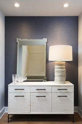 The vignette at the bottom of the stairs into the lower level features DesignTex wallcovering and a buffet from West Elm.