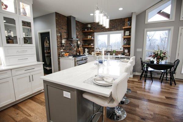 Farmhouse style kitchen with floating shelves. Yorktowne Calhoun Maple cabinets in sea salt classic color.