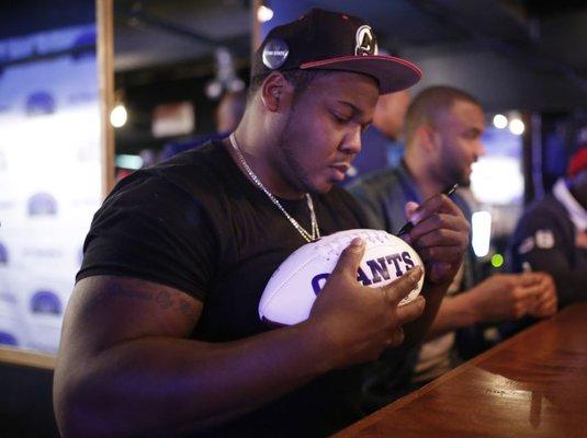 New York Giants Super Bowl XLII Champion Jay Alford signing autographs for fans at one of our view parties