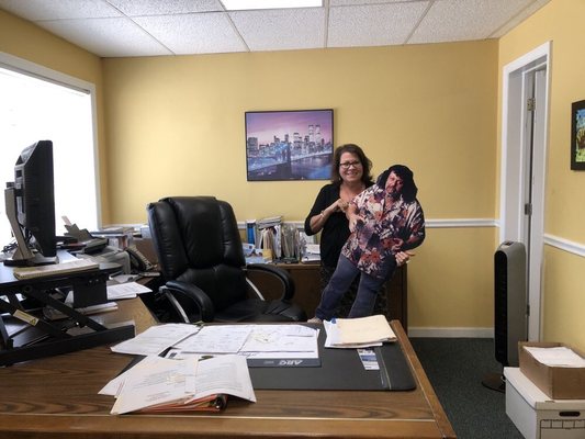 Anita Albano holding a Captain Lou Albano cardboard stand in the Albano Insurance Agency!