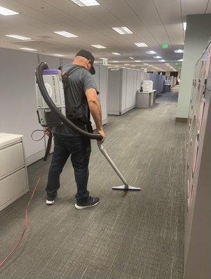 Carpet vacuuming in office with backpack vacuum