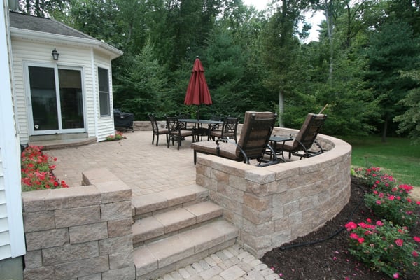 New raised paver patio and sitting wall with plantings