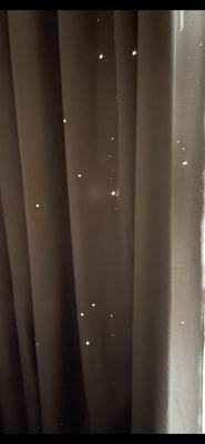 Pin sized holes in the curtains...