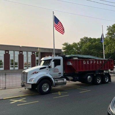 Truck 128 with a 20cy container from a cleanup project near Girard and Ridge