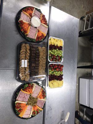 Fruit , meat cheese and cookie trays