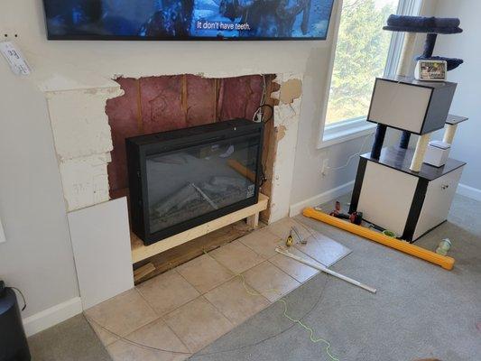 Customer just bought the house and wanted it updated we put a new Fireplace in and built and new mantle with tile on the wall and mantle