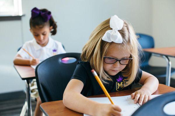 Our kindergarten students are working on their journals.