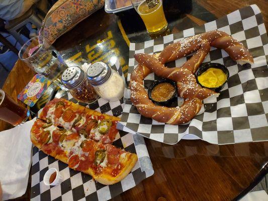 Partially eaten spicy pepperoni and giant soft pretzel (with mustard, but wish it waa cheese!)