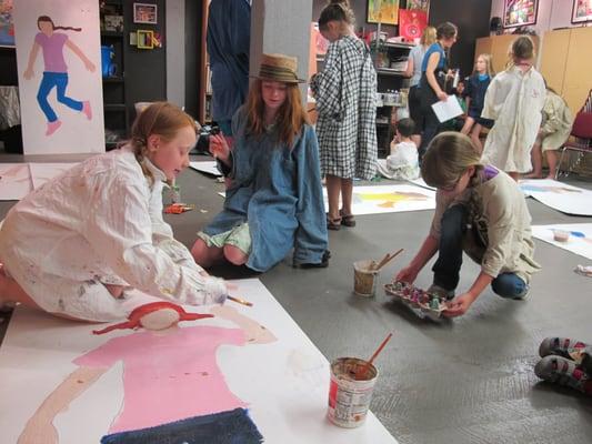 Participants in Art Access' workshops for children ages 5-11 making life-size self portraits.