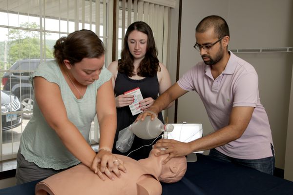 Teams of rescuers work to revive a mock patient during an Advanced Cardiac Life Support course at Code One.