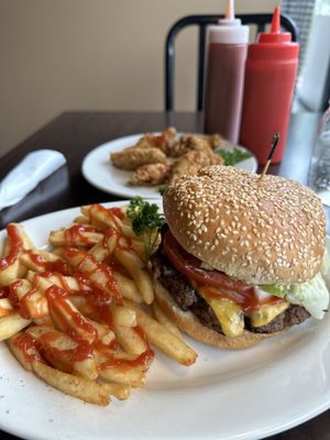 Cheeseburger with lettuce tomato onion and fries