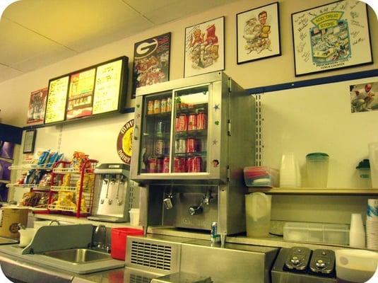 The milk machine,cold soft drinks, and a partial menu.