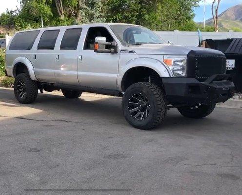 This 6-door Ford Excursion with dual gas tanks was a custom build and we are so proud - what a beast!