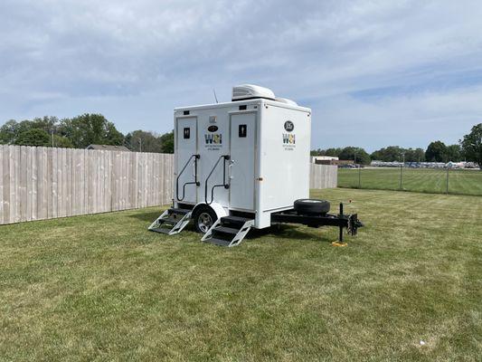 Small portable restroom trailer with running water, flushing toilets, electricity and temperature controlled.