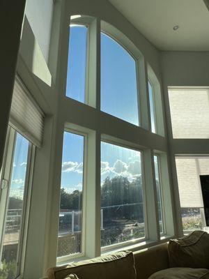 Living room windows with tinting to block glare and UV but not impede the view or the open/bright feeling.