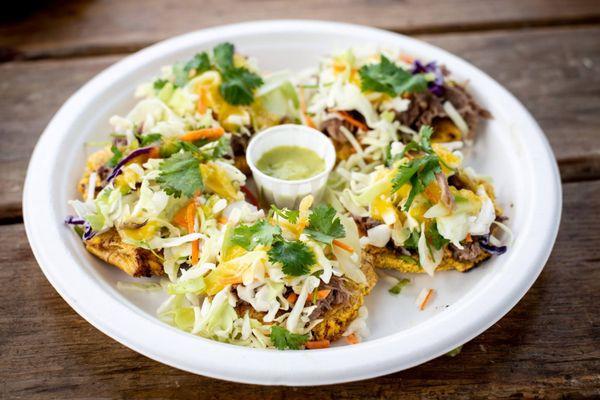 Mofongo bites! 2ice baked green plantains topped with your choice of protein ,coleslaw