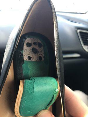 Inside of sole which was cut poorly with screw holes exposed