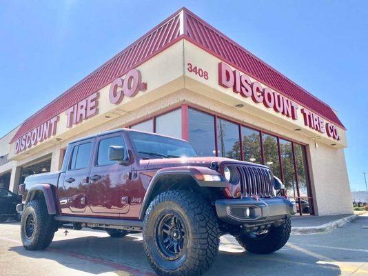 New Wheels & Tires in front of store.