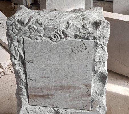 A slab of granite being transformed into an early 20th century style headstone.