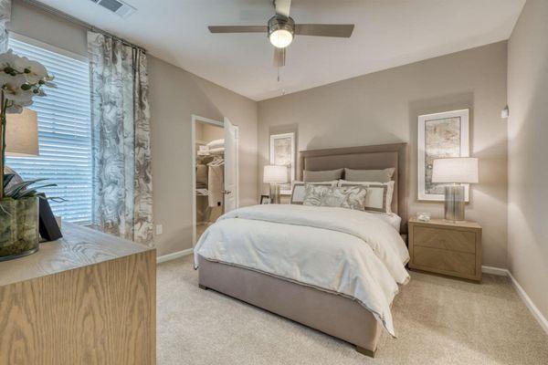 a bedroom with a bed and a ceiling fan